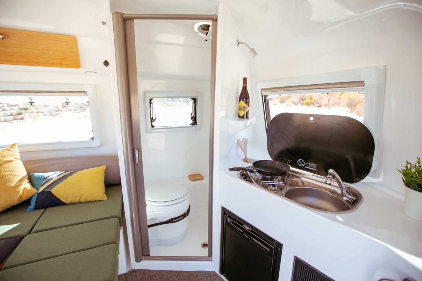 The kitchen includes a fridge, dual-burner stove and sink