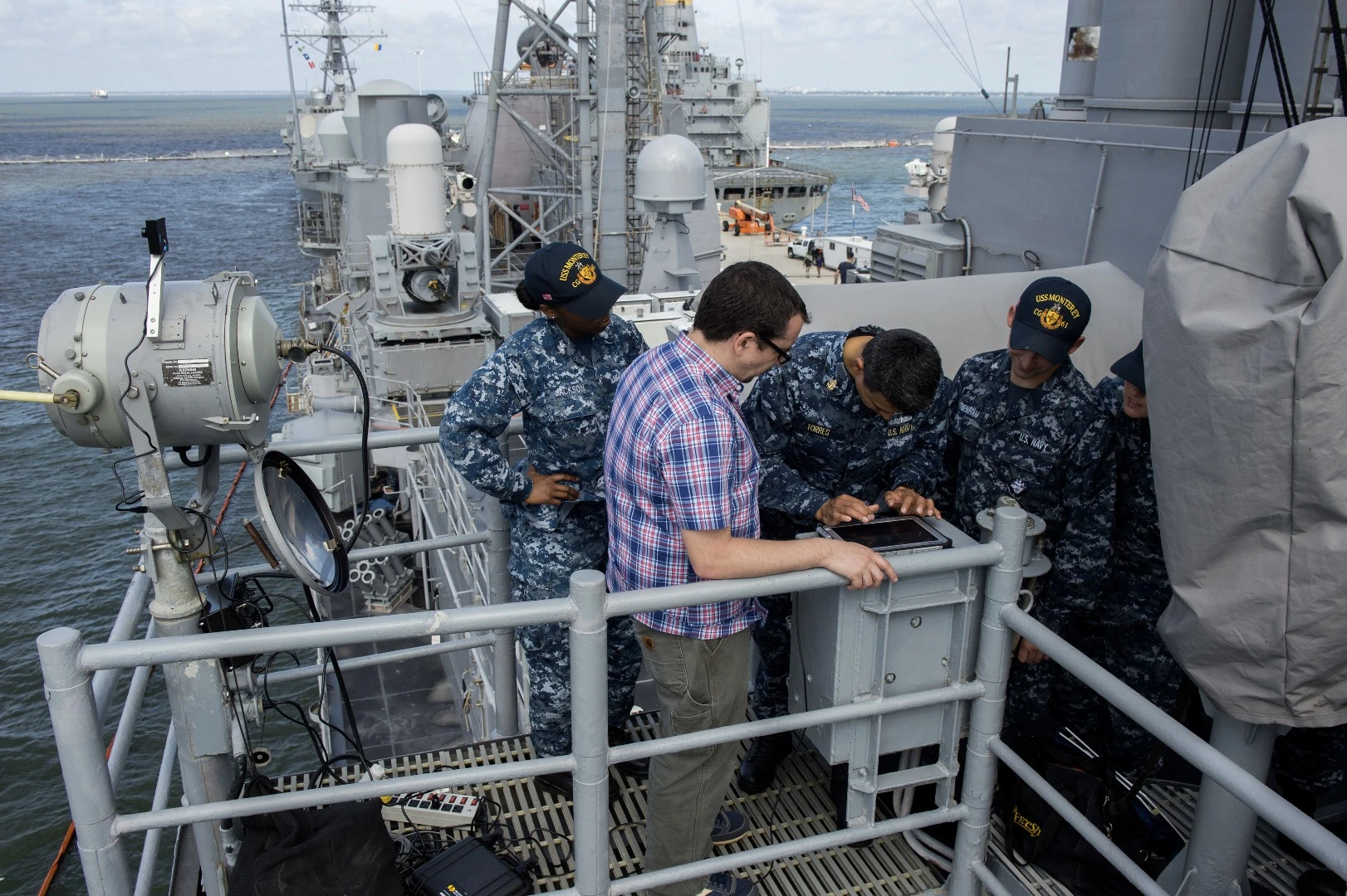 Eric Gallo with Creative MicroSystems Corp. watches as Chief Quartermaster Efrain Torres types a message during a demonstration of the Flashing Light to Text Converter (FLTC)