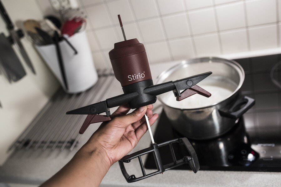 The new model features an articulated plastic stirring blade that can be folded out to reach across the bottom of different sizes of pots