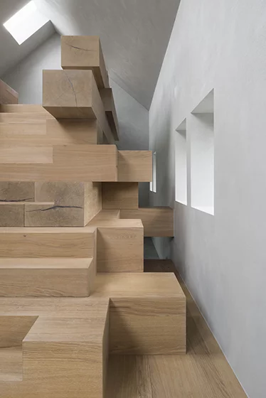 "The stacked beams become library, bookshelves, storage and resting and reading corners," says Studio Farris Architects