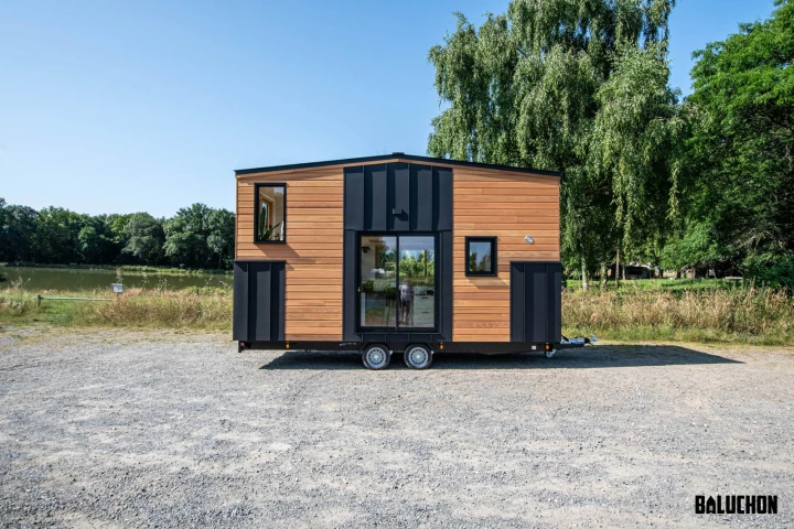 The Nouvelle Dans, by Baluchon, is a compact tiny house that has a space-saving upside-down layout