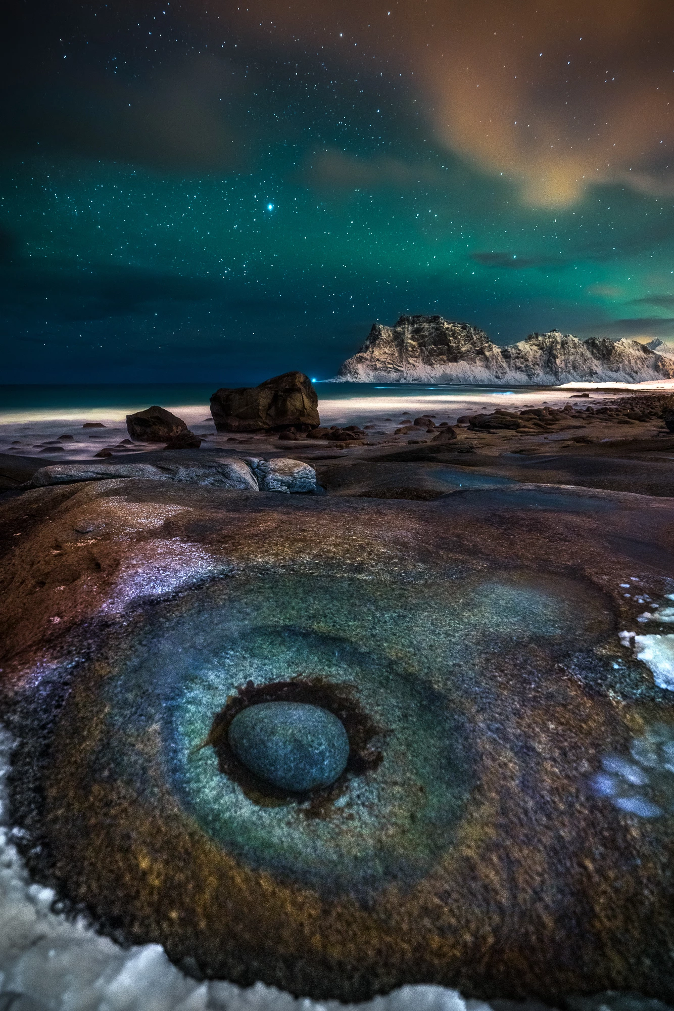 A Norwegian beach beneath the magical Northern Lights