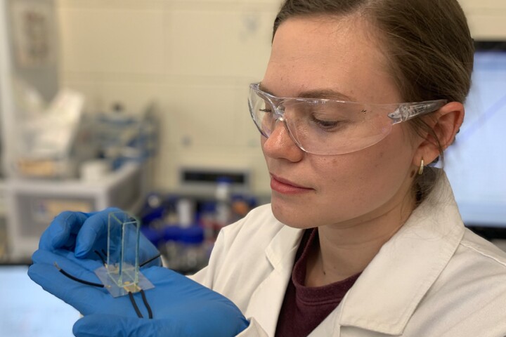 PhD researcher Yemima Ehrnst holding a simple acoustic device used to radically boost hydrogen production during electrolysis