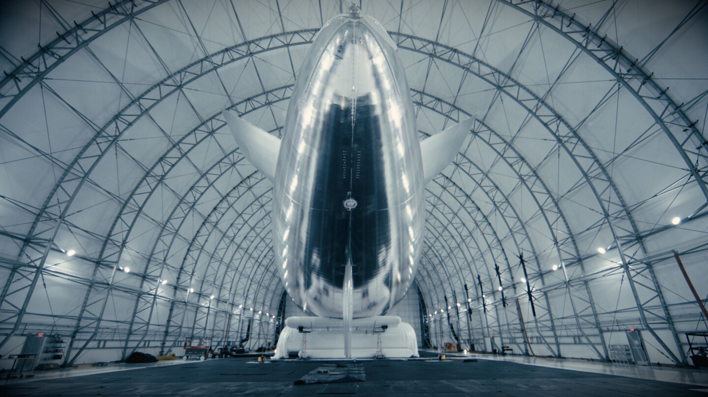 The aircraft's electric motors are powered by solar cells which are integrated into its full-body silver-foil "solar cape"