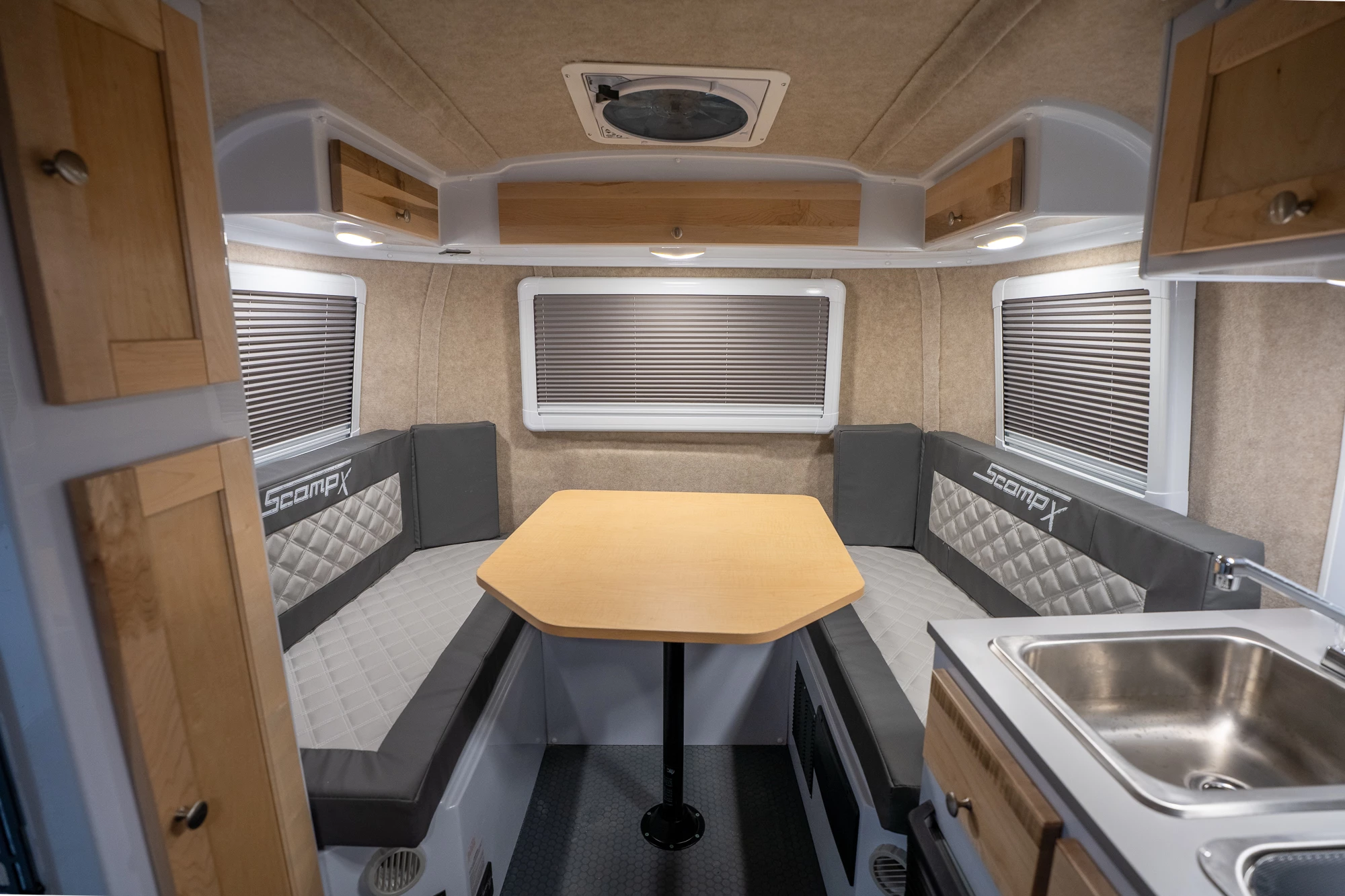 Both the TRK and ALT floor plans include a U-shaped rear dinette that converts into the main bed
