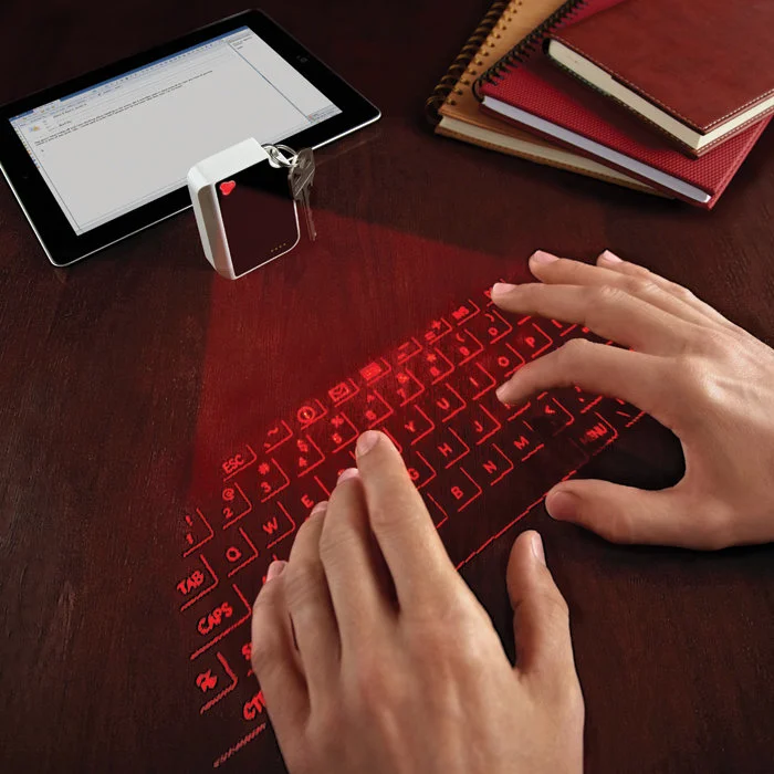 CTX's Virtual Keyboard projects a usable laser outline of a QWERTY keyboard onto any flat surface while fitting inside a small keychain