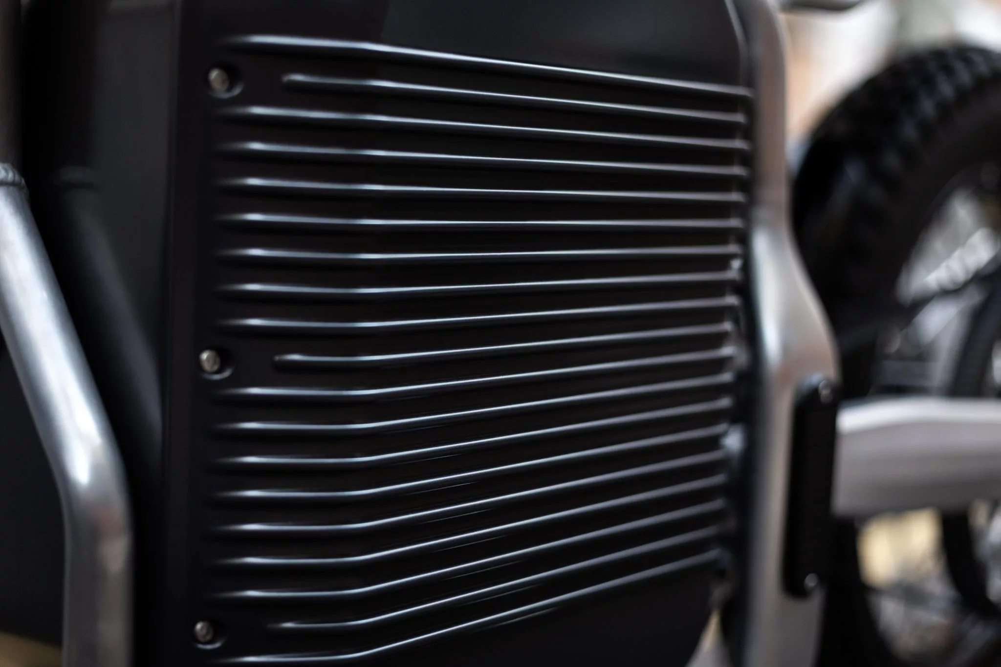 The large battery housing has cooling fins on the outside