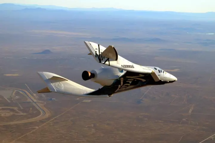 SpaceShipTwo's first glide in powered flight configuration with the rocket motor nozzle visible
