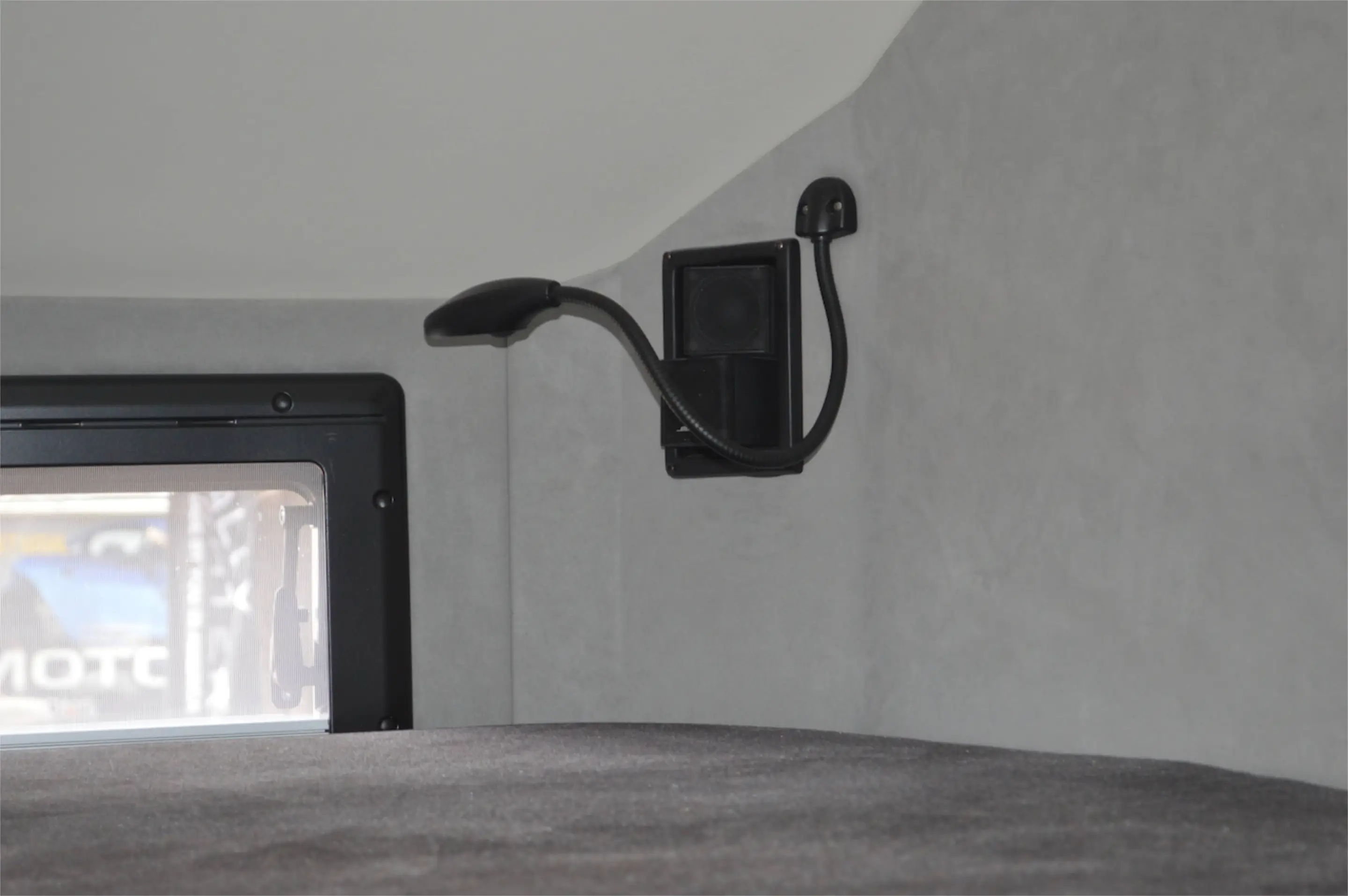 Lighting and Bose speakers mounted in the corner over the above-cab bed