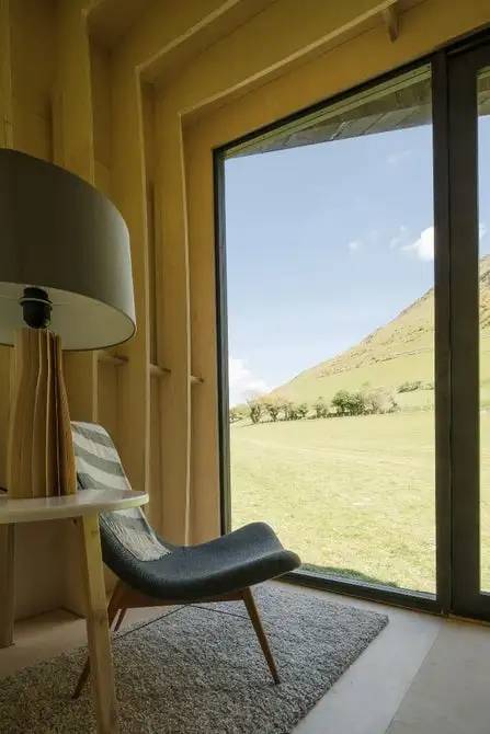 A floor to ceiling glass door allows occupants to enjoy stunning views of the surrounding landscape