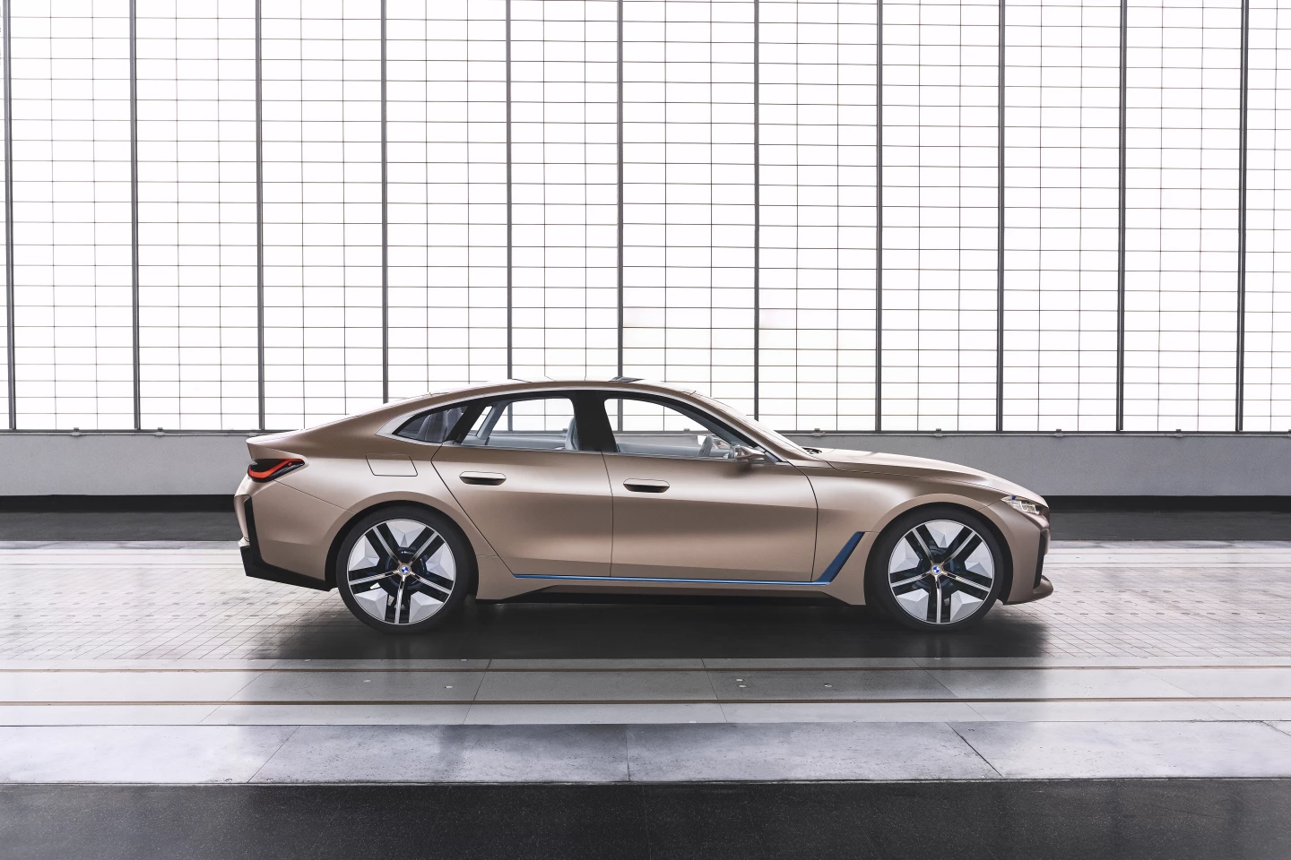 The sloping fastback roofline ends in L-shaped rear lights, with angled lips below for enhanced aerodynamics
