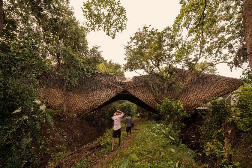 The Bridge House has been built across a 7-m gorge in rural India, using steel and mud with a pangolin-inspired roof
