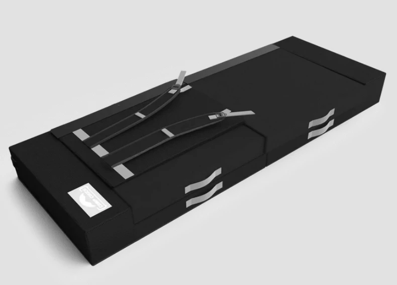 The Camp Couch kickstands fold flat, then the whole package folds in half and buckles in place