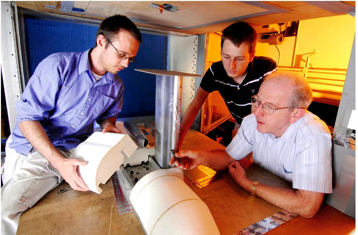 GTRI researchers (from left) Graham Blaylock, Nicholas Moore and Robert Englar assemble a test aircraft's fuselage onto the blown wing assembly, while also measuring the height of the blowing jet exit slot. (Photo: Gary Meek)
