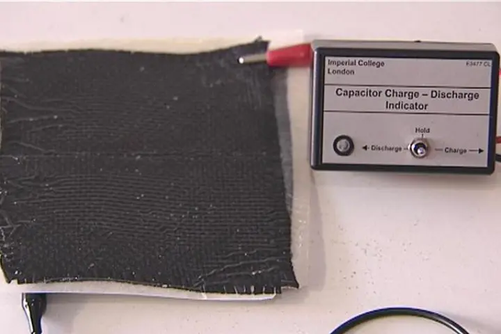 The composite material releasing electrical energy to power a small light (Photo courtesy of Imperial College London)