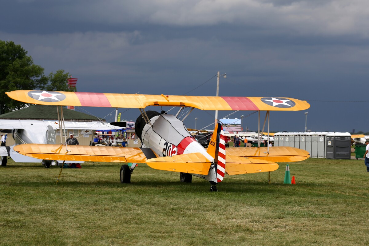 A Stearman bi-plane waits out the storm (Photo: Angus MacKenzie/Gizmag.com)