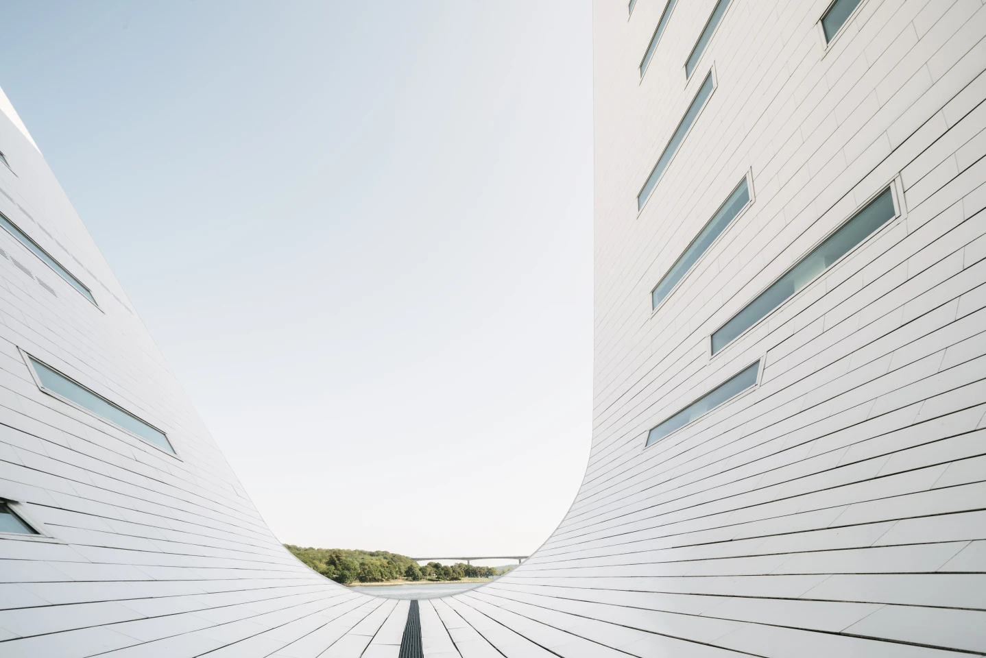 The sculpted wave-like structures that house the apartments have skylights installed to maximize light inside