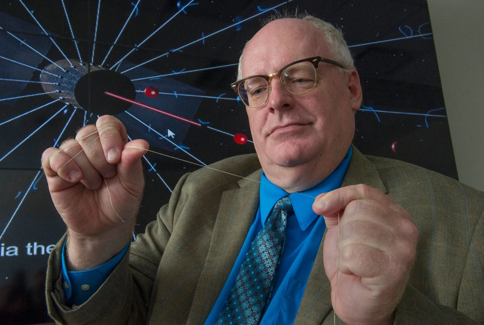 NASA engineer Bruce Wiegmann, principal investigator for the HERTS E-Sail, demonstrates the long, thin wires that will construct the E-Sail