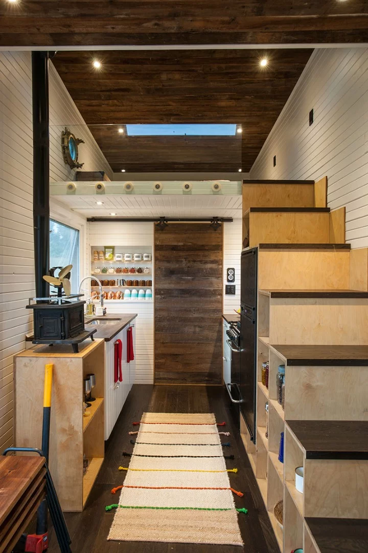 The Greenmoxie Tiny House features one bedroom loft, which is accessed by a storage-integrated staircase