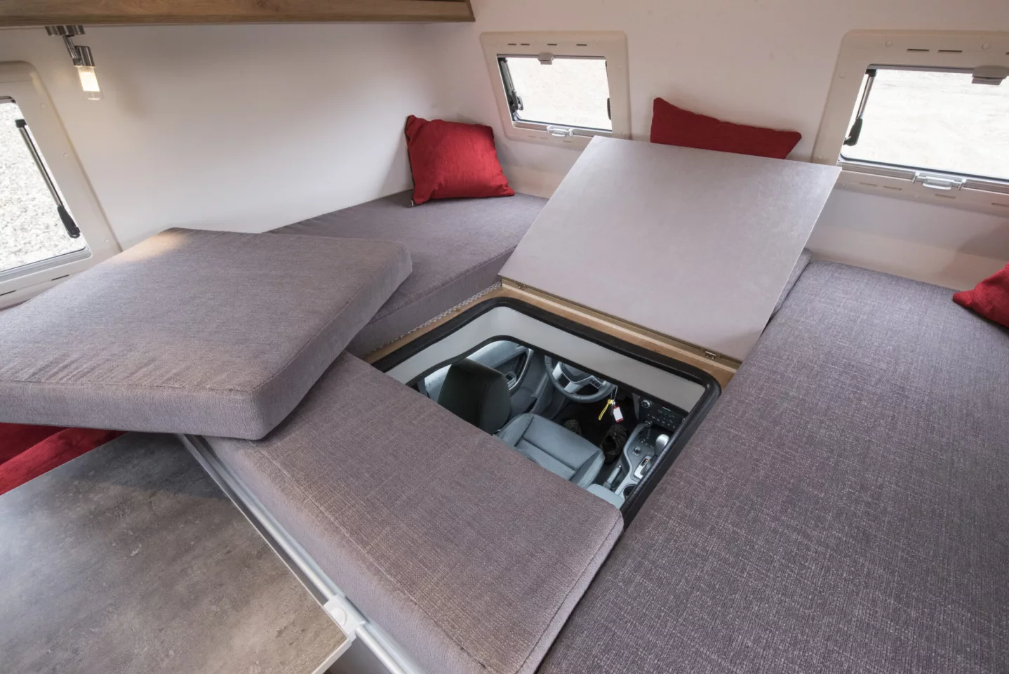 Pop the cushion, flip open the hatch door and you can get from the alcove bed to the driver's seat in seconds