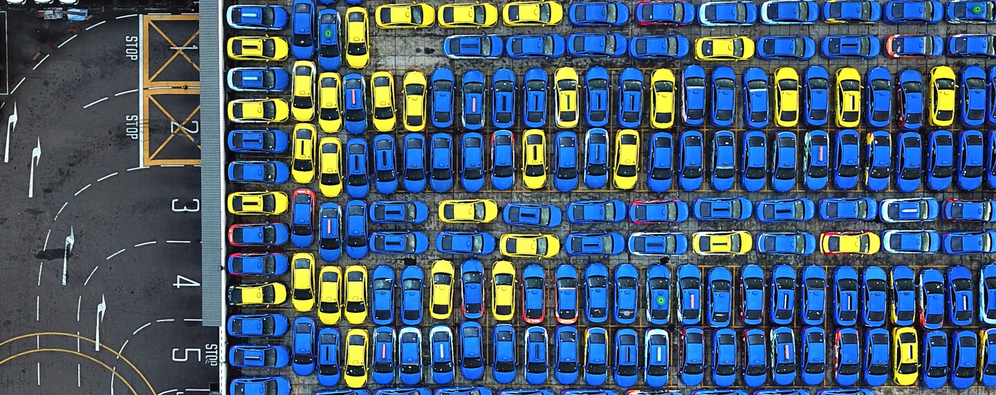 A panoramic view of unused taxis parked on the rooftop of a building during the COVID-19 pandemic