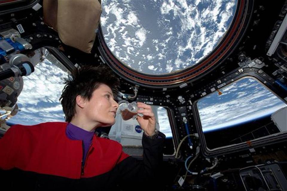 Italian astronaut Samantha Cristoforetti in Star Trek gear, enjoying an espresso