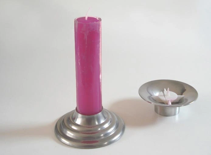 The used wax from several candles forms a whole new candle, which can then be placed up top, lit and the whole process starts over again