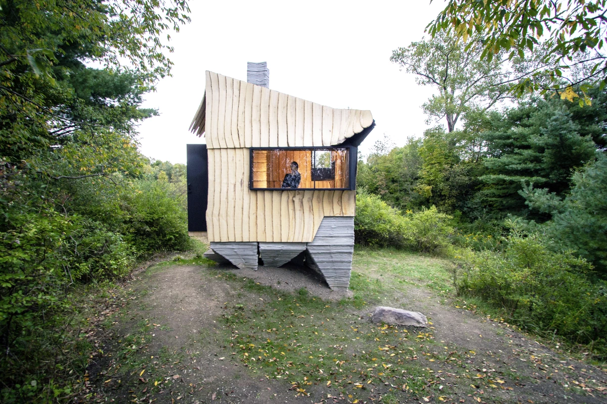 Ashen Cabin's concrete base was created with a 3D printer, while its wooden exterior was cut using a robotic arm that was previously used to build cars for General Motors