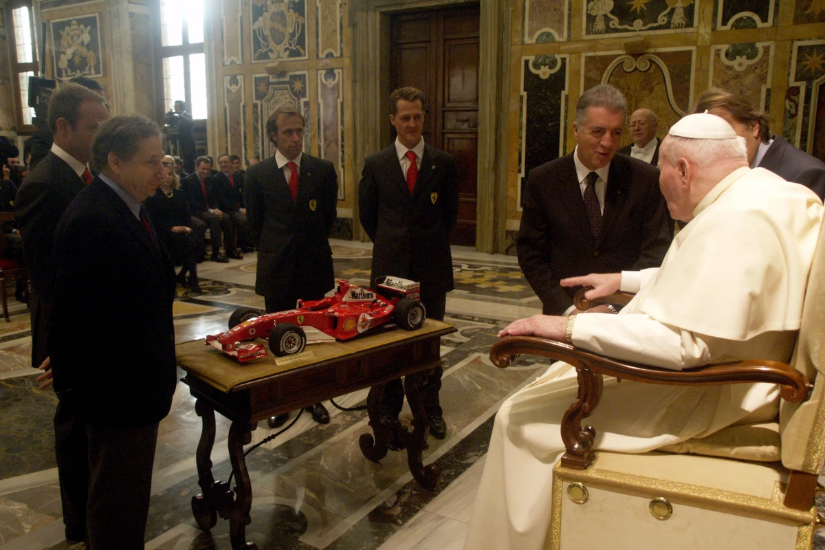 It all started when then Pope John Paul II (now Saint John Paul) met a Ferrari delegation at the Vatican in January 2005. Present were (from right to left), Ferrari President Luca Cordero di Montezemolo, Saint John Paul, Piero Ferrari, Michael Schumacher, Luca Badoer, Jean Todt, Rubens Barrichello, and 90 other Ferrari employees. The intention was to present the Pontiff with a scale model F2004 F1 car, but the event was profoundly moving and within a few hours of its conclusion, a 400th and final Ferrari Enzo had been pledged to the benefit of Tsunami victims: the Pope's Ferrari