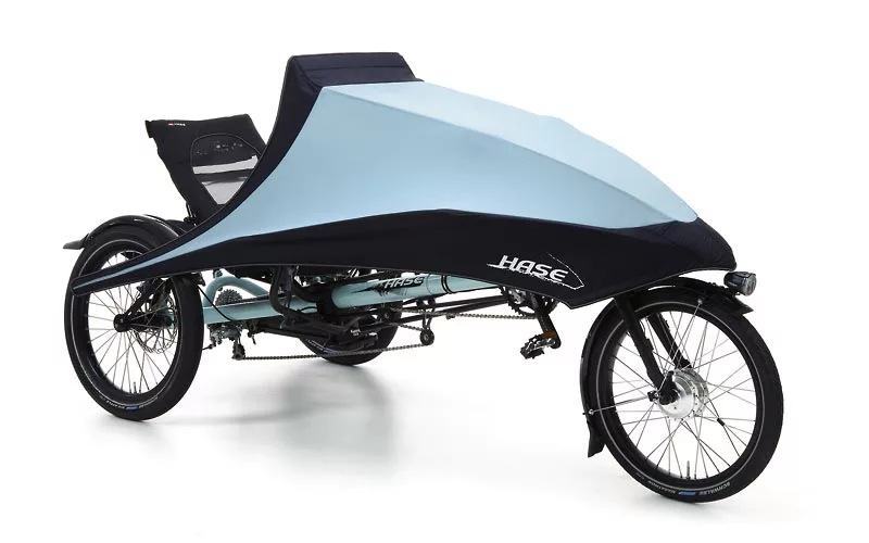 Hase Bikes' KLIMAX tricycle features a detachable folding fairing, allowing users to add weather protection as needed