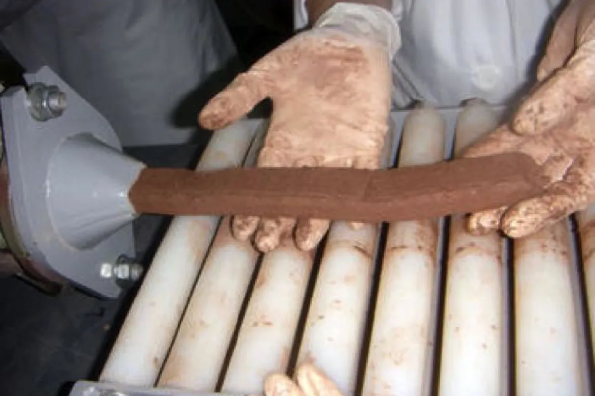 A length of the paper-based bricks being extruded