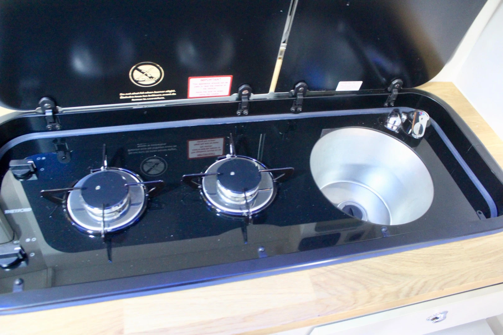 The Barefoot Caravan has an interesting little kitchen layout with a sort of carved-out bucket sink