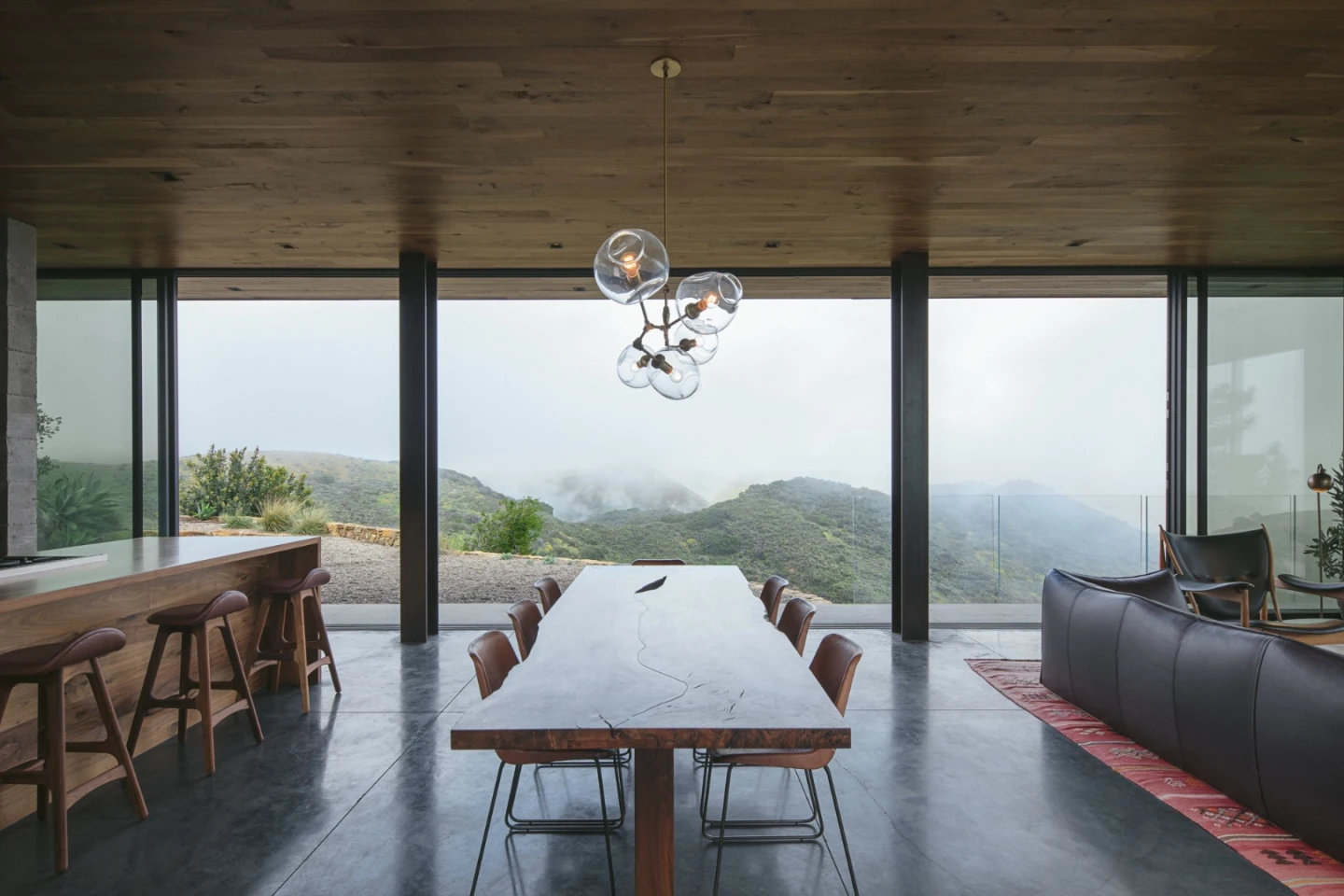 The Off-Grid Guest House is kept a comfortable temperature with a combination of radiant floor heating, cross ventilation from the operable sliding glass, a pellet burning stove, and an insulating green roof