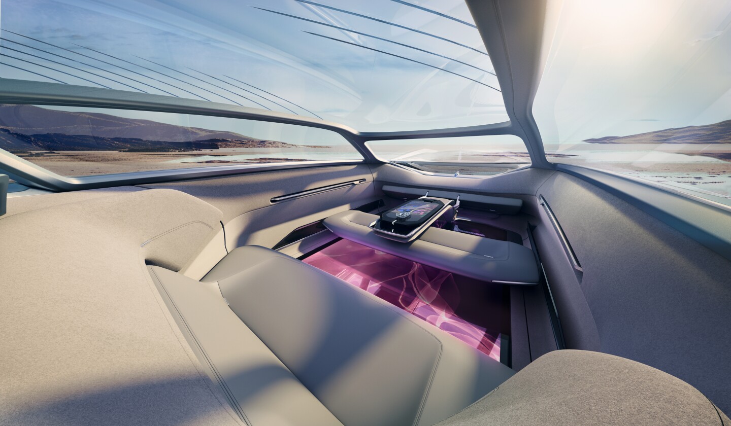 The interior includes a rear sofa, convertible front bench seating and a center console control center