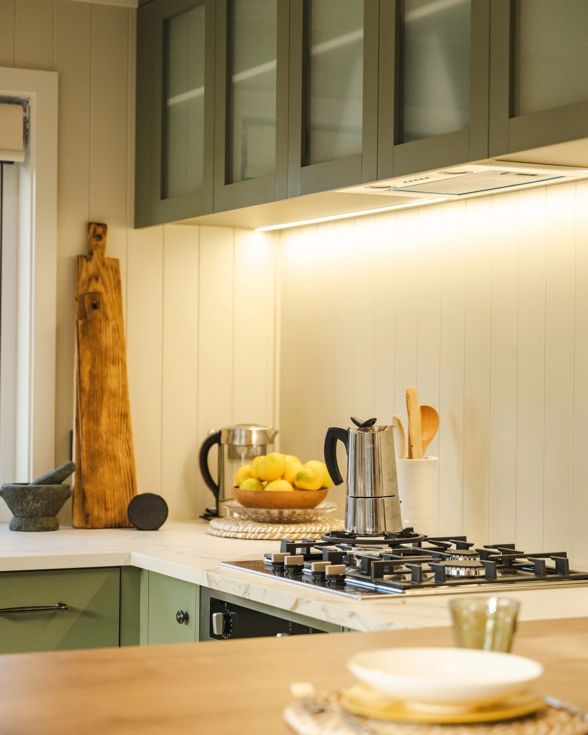 The English Garden's kitchen includes an oven with propane-powered cooktop, a farmhouse-style sink and a fridge/freezer