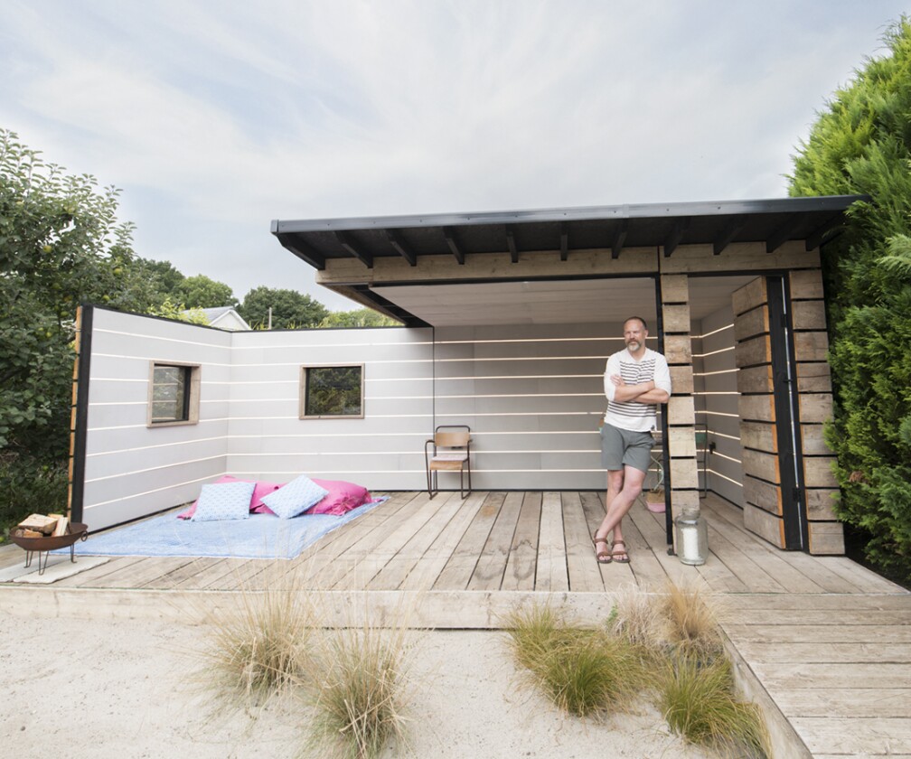Two of Scaffold Board Summer House's walls rotate when the space needs to be opened up