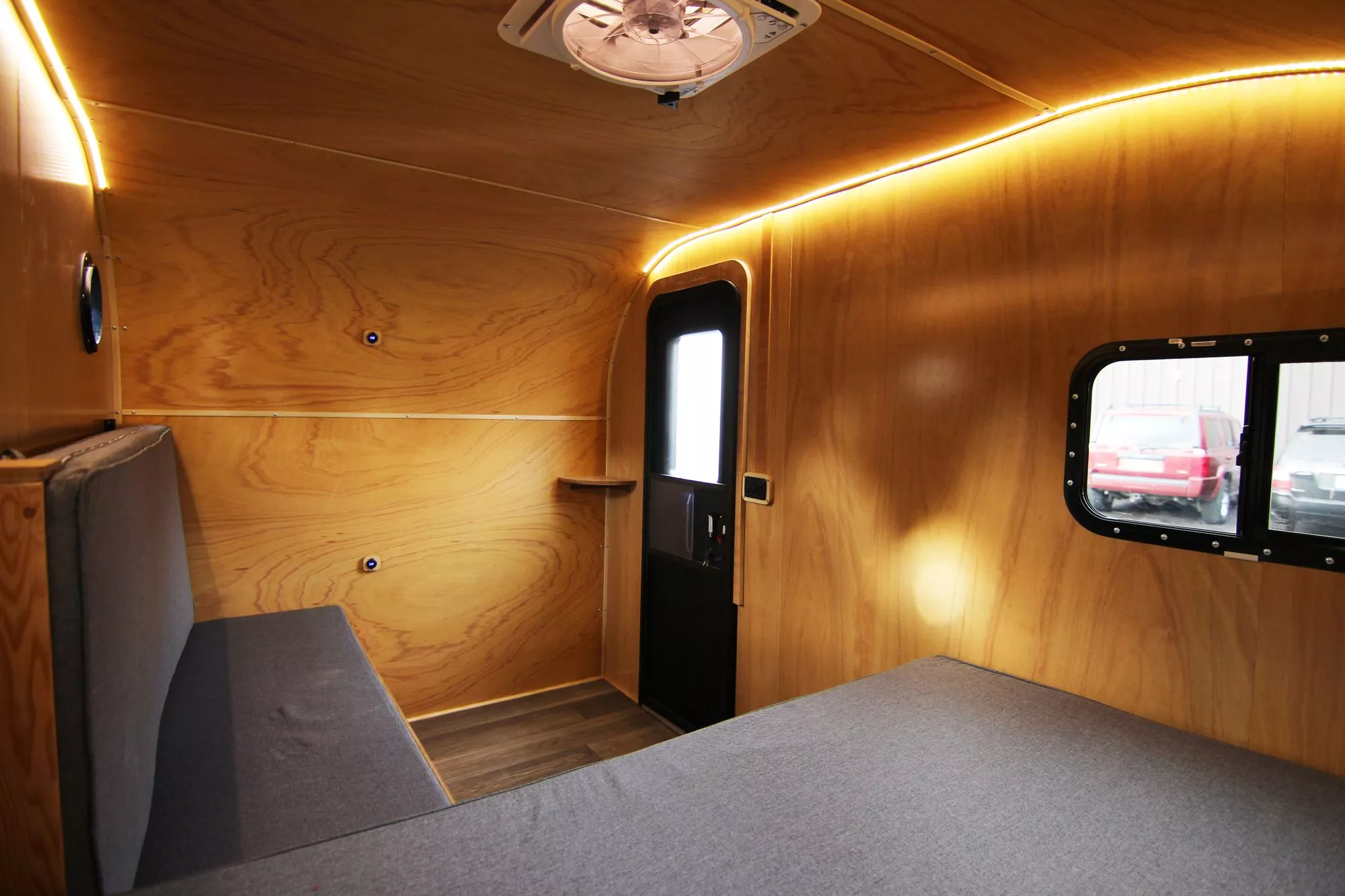 The top bunk folds down to create a backrest for the sofa bench