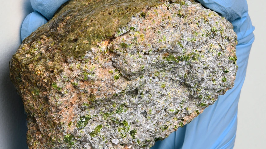 NWA 11119 is a much lighter color than most meteorites, and is speckled with green crystals that are high in silica