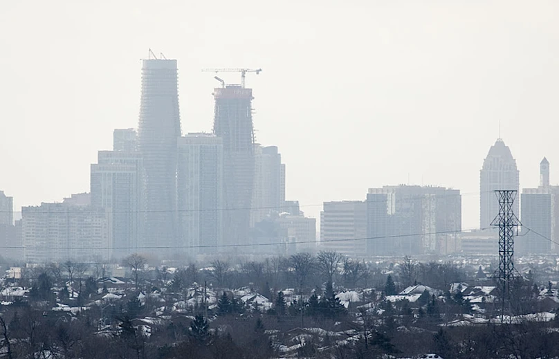 The Absolute Towers under construction during an Ontario winter