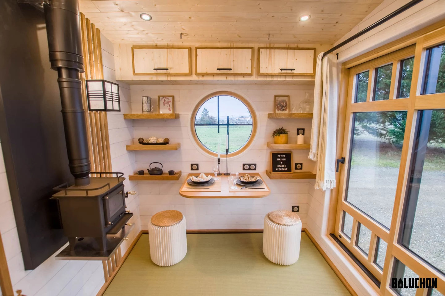 The Bonzai tiny house's multipurpose living room features Japanese-inspired interior decor and generous glazing
