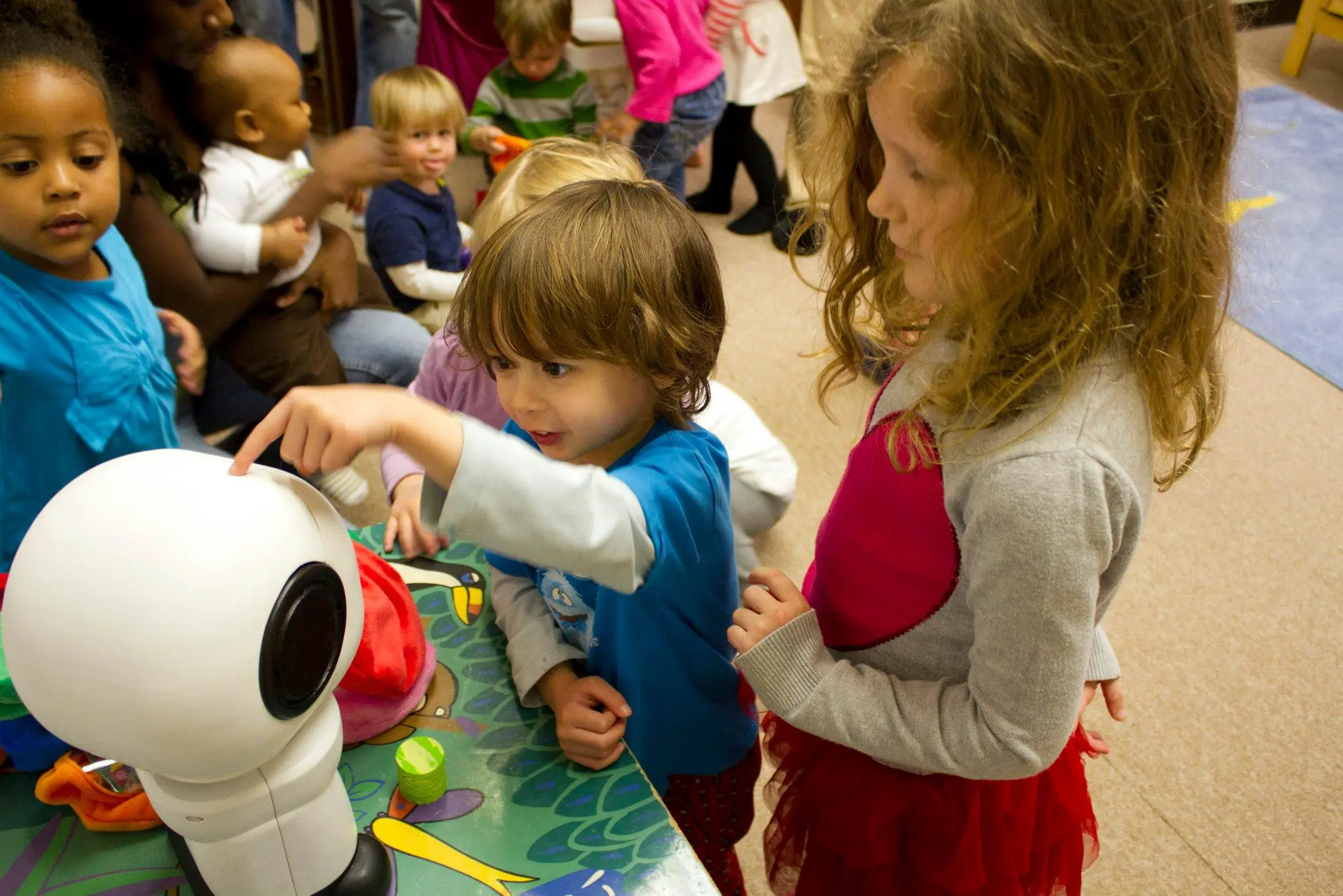 Children interact with Hello Robo's communication robot, MAKI