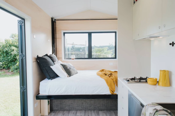 The Camper Tiny House's most notable feature is its pull-down bed which is stowed away near the ceiling when not in use
