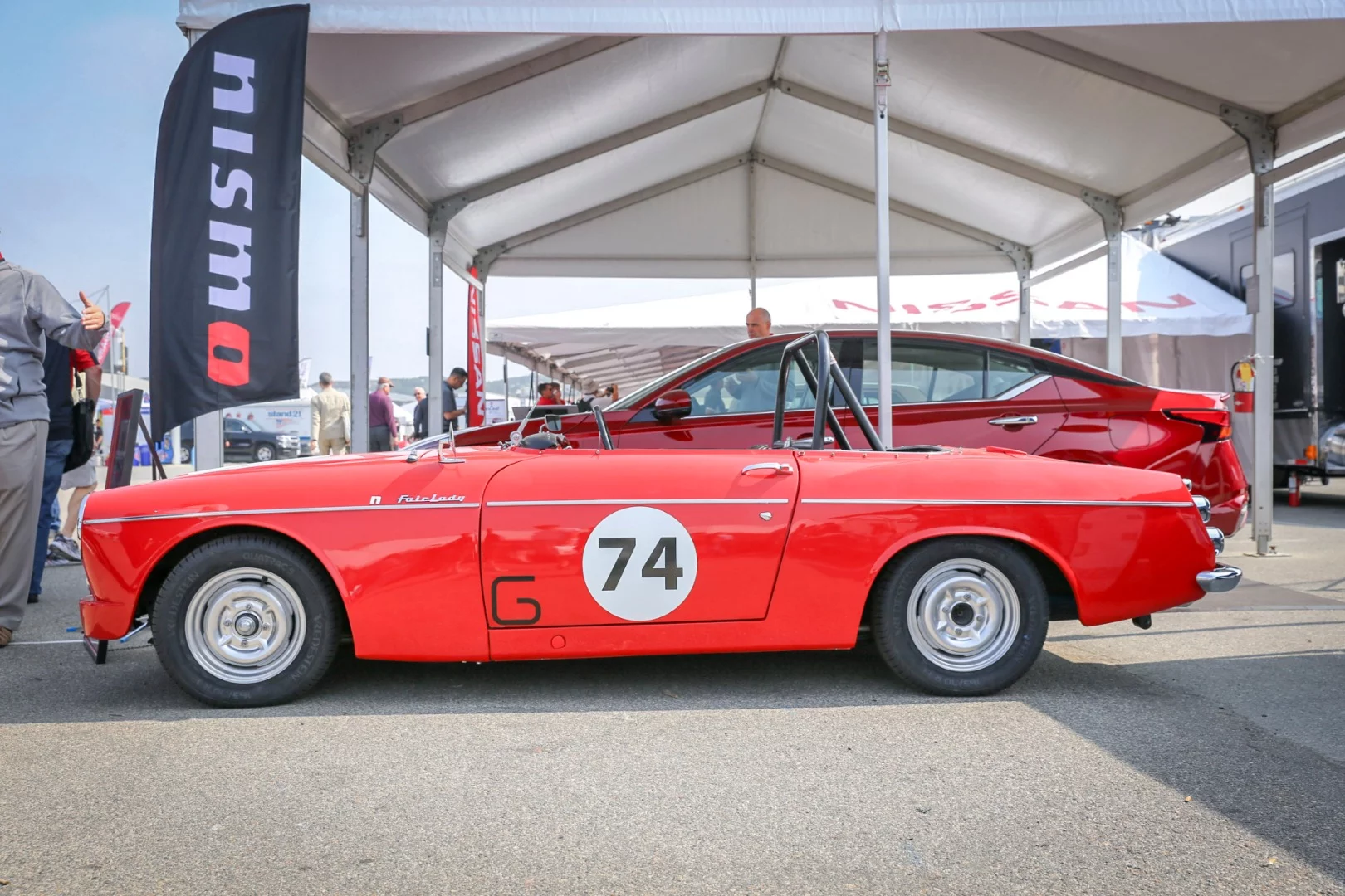 1960s era Datsun Fairlady racing roadster resides inside the Nissan paddock