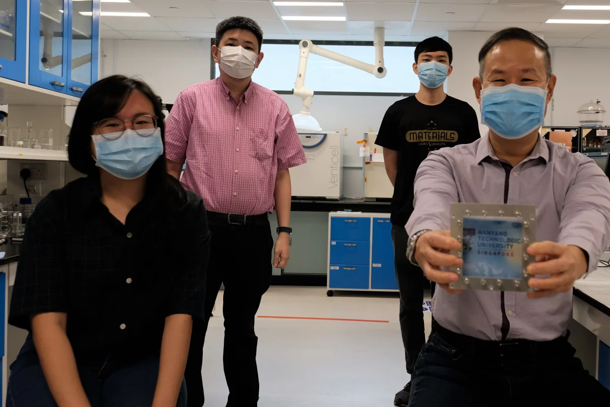The NTU Singapore team with a sample of window glass incorporating the material