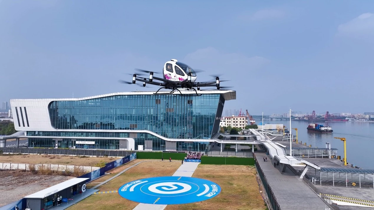 The pilotless EH216-S eVTOL can carry two paying customers per sight-seeing trip above the city port of Guangzhou
