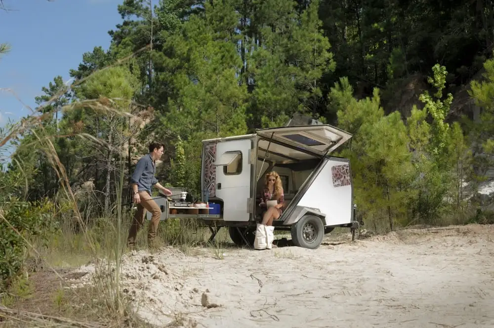 The Taxa TigerMoth kitchen slides out the rear and stores under the convertible couch