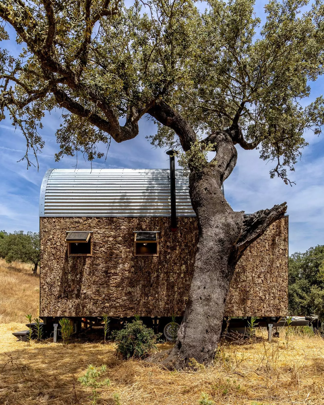 The Terra m1_Tiny House on Wheels is topped by a distinctive curving roof