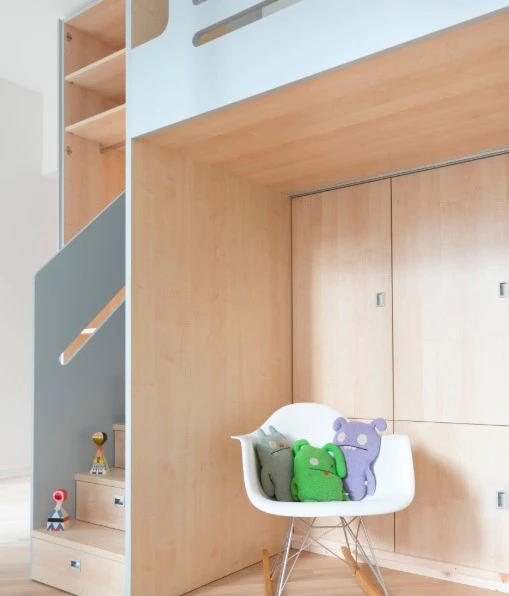 The custom-made wooden unit is complete with wardrobe and storage space