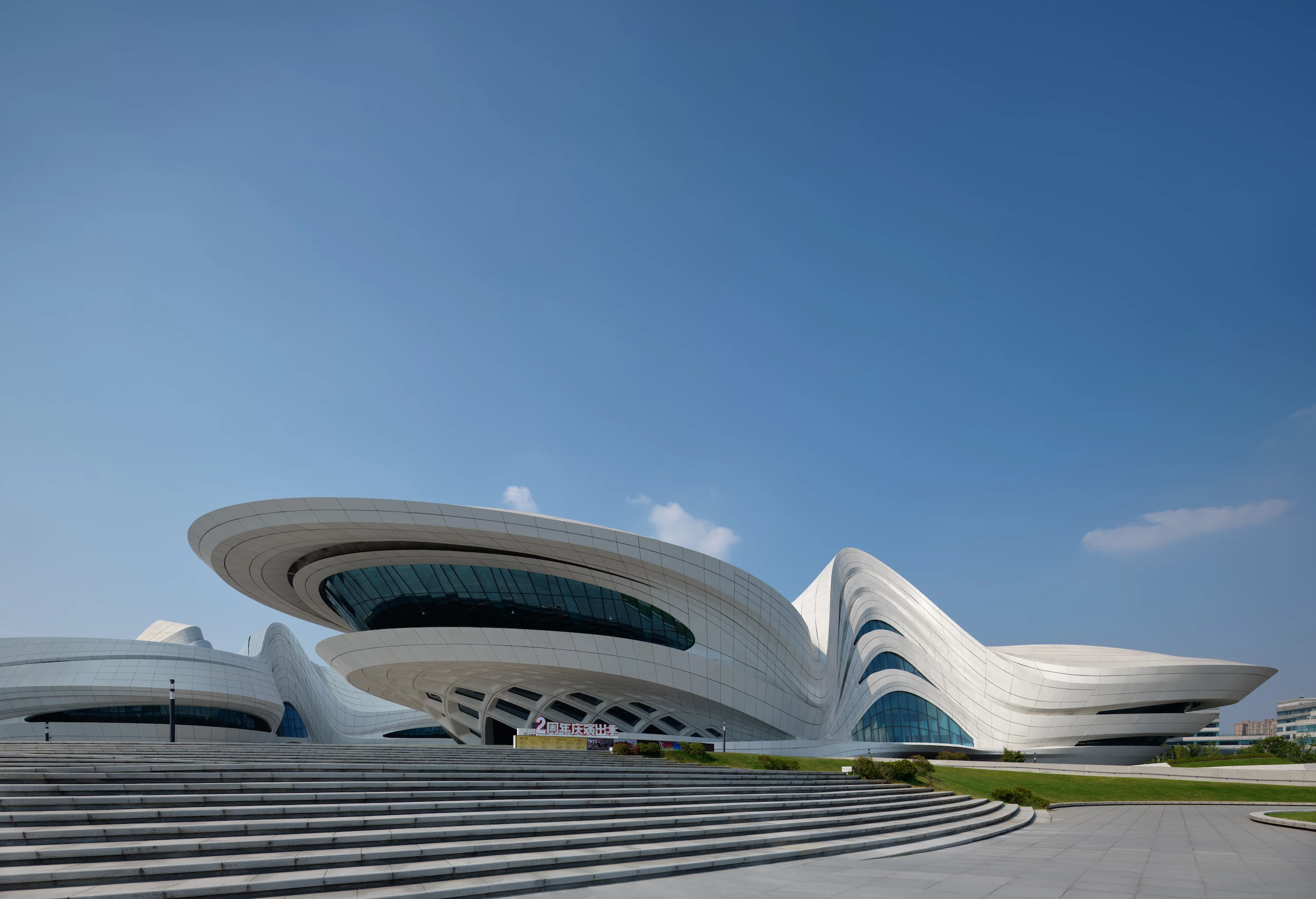 The Changsha Meixihu International Culture & Arts Centre is split into three separate buildings that are arranged around pedestrian routes that crisscross the site