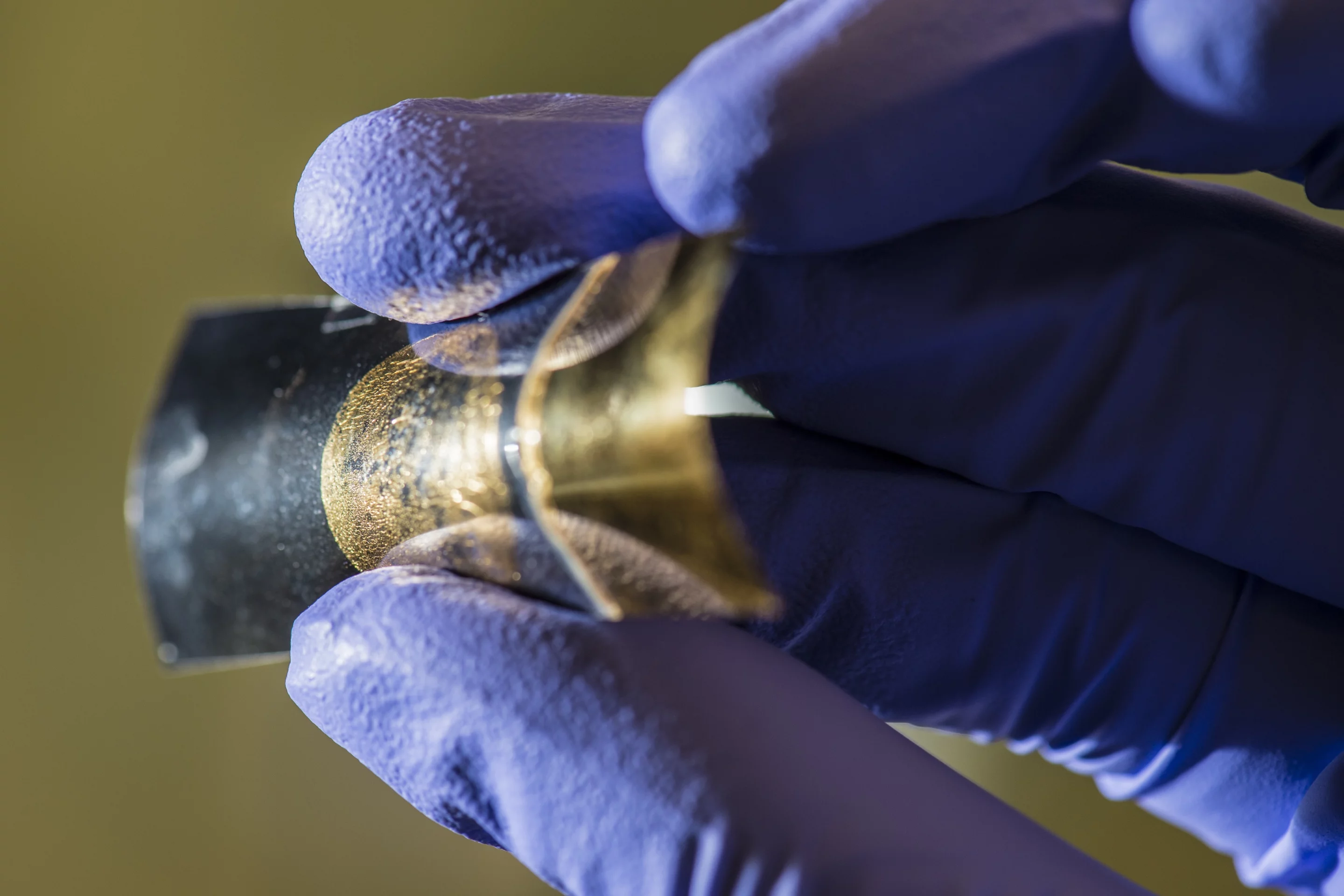 A thin-film energy storage device, seen attached to a polymer backing, retains its battery- and supercapacitor-like qualities even after being flexed 1,000 times, according to tests at Rice University (Image: Tour Group/Rice University)